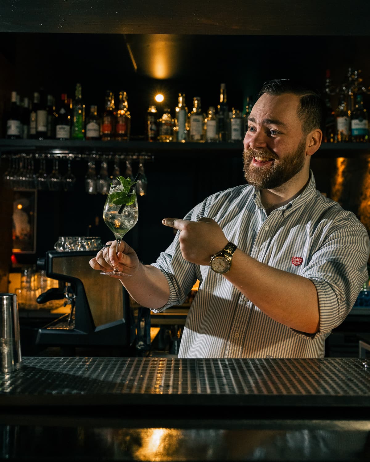 A bartender at Daisy points to a nice looking cocktail